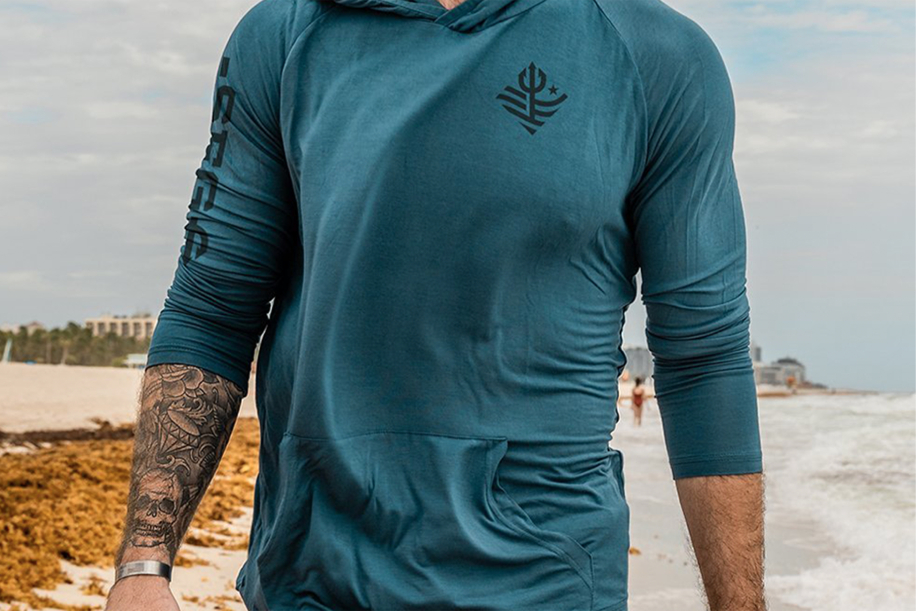 Man in blue hoodie with logo and arm print