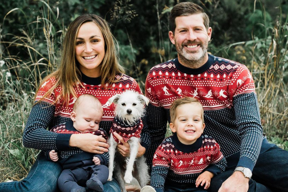 Family with dog in matching sweaters